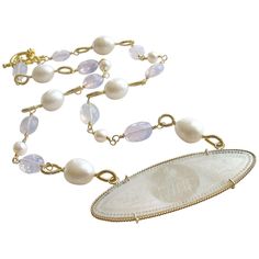 La Finesse Armorial Monogram Necklace. This beautiful and delicately carved Chinese gaming counter (circa 1810) has found a new life as the centerpiece of a stunning and elegant necklace of Lavender Moon Quartz and freshwater baroque pearls. The ethereal faceted oval Lavender Moonstone Quartz gemstones, with their shimmering aldurescent properties, alternate with creamy freshwater baroque pearls featuring hand-coiled loops. Safely suspended in a twist wire frame of 14k gold, this unique hand-engraved Mother-of-Pearl pendant is just as beautiful on the opposing side, featuring the same heraldic lion’s head monogram (FHM) on the reverse. During the early 1700’s, wealthy European families commissioned Chinese artisans to make finely engraved sets of mother-of-pearl gaming counters for use in Gambling Chips, Purple Flower Necklace, Lavender Moon, Monogram Pendant Necklace, Moon Quartz, Purple Pendant Necklace, Necklaces Beaded, Lion Pendant, Quartz Pendant Necklace