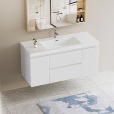 a bathroom vanity with two mirrors above it and a rug on the floor next to it