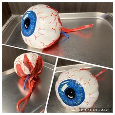 an eyeball with blue and red paint on it is sitting in a metal pan