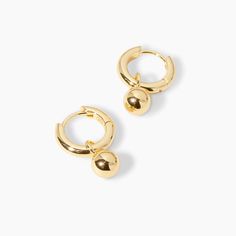 This drop earring features a chic huggie with an attached gold bead that moves with you. This earring is the perfect simple statement. 1/2" profile diameter 1/8" wide Charm diameter 1/4" Hinge post closure Available in 18k gold plated brass Avoid contact with anything containing derivatives of alcohol Single Brass Huggie Earring, Gold-tone Brass Huggie Earrings, Hypoallergenic Brass Drop Huggie Earrings, Gold-tone Huggie Earrings, Gold Dangle Huggie Earrings With Lever Back, White Aura, Gorjana Jewelry, Black Labradorite, Orange Agate