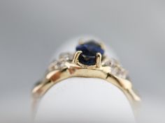 "Sophisticated and refined, this marquise sapphire ring is low set enough to wear day to day, as well. The diamonds accents provide glitter without being overly ornate, and provide a perfect frame for the luscious blue sapphire we've set at the center! Metal: 14K Yellow and White Gold Gem: Sapphire 1.58 Carats Gem Measurements: 10.4 x 5.0 mm, Marquise Cut Accents: 6 Diamonds totaling .09 Carats, H in Color, SI in Clarity Ring Size: 5.25 Marks: \"<>14K\" Stamped on the inside band SKU #: YR Marquise Sapphire, Yellow Gold Sapphire Ring, Diamond Ring Vintage, Dinner Ring, Vintage Sapphire Ring, Ring Sapphire, Vintage Sapphire, Sapphire And Diamond Ring, Cameo Ring