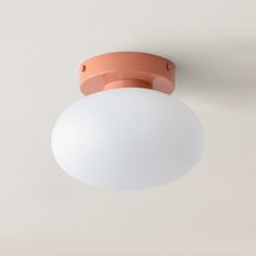 an orange and white light fixture on the ceiling