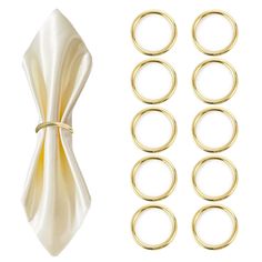 gold plated metal rings and napkins on a white background