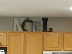 the letters n, f, and h are on top of cabinets in this kitchen