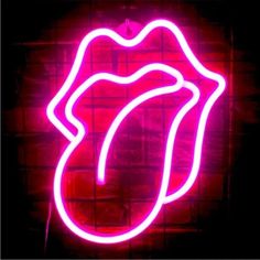 the rolling stones neon sign in front of a brick wall