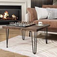 a living room with a couch, coffee table and fire place in the fireplace area