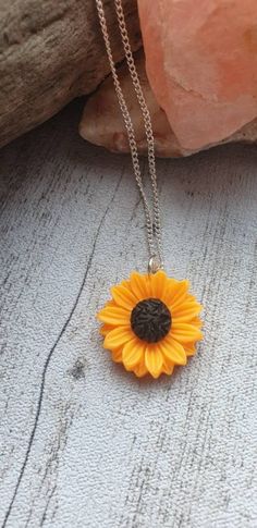 Sunflower necklace with sunflower pendant. This vibrant sunflower necklace is a great piece of statement jewellery that will add colour to any outfit and sunshine to your day! The sunflower pendant comes on a silver plated chain. Yellow Sunflower Print Jewelry For Gift, Yellow Sunflower Print Jewelry As Gift, Yellow Sunflower Print Jewelry Gift, Yellow Flower Shaped Jewelry With Sunflower Print, Yellow Flower-shaped Jewelry With Sunflower Print, Sunflower Design Flower Necklace Gift, Yellow Flower Pendant Necklace With Sunflower Design, Yellow Sunflower Design Flower Pendant Necklace, Witch Bracelet