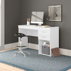 a white computer desk sitting on top of a blue rug