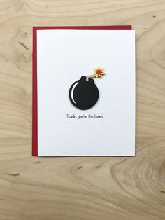 there is a card with a black pot on it and a yellow flower in the middle