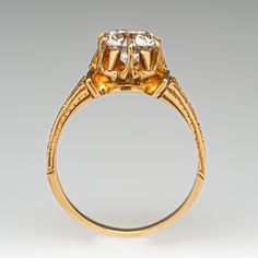 This marvelous circa 1900 ring is centered with one (1) old European cut diamond weighing 1.33 carats that is set into a six-prong setting. Engraved detail accented the shoulders of the ring. The ring measures 8.5mm at the top, rises 7.0mm above the finger, tapering to 1.8mm wide and 0.9mm thick at the base of the shank. It is currently a size 6.5. Victorian Yellow Gold Diamond Ring With Center Stone, Antique Yellow Gold Diamond Ring With Center Stone, Antique Solitaire Yellow Gold Wedding Ring, Victorian 14k Gold Diamond Ring With Center Stone, Antique 14k Gold Wedding Ring With Prong Setting, Antique Diamond Ring With Prong Setting And Round Cut, Antique Yellow Gold Diamond Ring With Prong Setting, Victorian Diamond Ring With Round Cut Center Stone, Victorian Solitaire Round Cut Diamond Ring