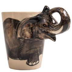 an elephant mug is shown with its trunk curled up in the shape of a coffee cup