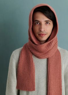 a young man wearing a scarf and sweater