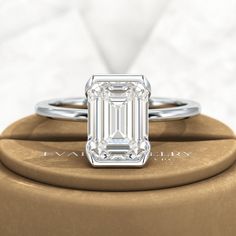 Introducing our stunning 2.50 Carat Emerald Cut Half Bezel Engagement Ring! Crafted with love, this exquisite ring features an emerald cut lab grown diamond set in 14K or 18K yellow gold. Its minimalist design exudes elegance, making it a perfect choice for your proposal. Trust us, this ring will leave her breathless!𝐅𝐞𝐚𝐭𝐮𝐫𝐞𝐬:• 𝐌𝐚𝐝𝐞 𝐭𝐨 𝐎𝐫𝐝𝐞𝐫• 𝐌𝐞𝐭𝐚𝐥: 𝟏𝟒𝐊 𝐆𝐨𝐥𝐝 | 𝟏𝟖𝐊 𝐆𝐨𝐥𝐝 | 𝟗𝟓𝟎 𝐏𝐥𝐚𝐭𝐢𝐧𝐮𝐦 • 𝐁𝐚𝐧𝐝 𝐂𝐨𝐥𝐨𝐫𝐬: Rose Gold, Yellow Gold & White Gold• 𝐁 Elegant Gia Certified Rose Gold Diamond Ring, Refined Emerald-cut Diamond Ring With Prong Setting, Refined Emerald Cut Brilliant Diamond Ring, Modern Emerald Ring In White Gold With Prong Setting, Timeless Cubic Zirconia Emerald Ring For Anniversary, Elegant Sterling Silver Baguette Cut Emerald Ring, Elegant Gia Certified Baguette Cut Emerald Ring, Elegant Baguette Cut Emerald Ring In Sterling Silver, Elegant Rectangular Emerald Ring Gia Certified