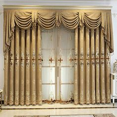 an elegant living room with gold curtains and rugs