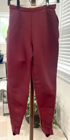 These vintage red stirrup pants are in good vintage condition. They have one  pocket with metal a metal zipper one the left side, and a metal zipper with a snap on the right side.  These eye-catching stirrup pants from the 1950s are a rare find! They feature a bold burgundy red that is sure to turn heads. The pants have a high waist and tapered leg with a stirrup strap that goes under the foot. They are in good vintage condition, with some minor signs of wear.  Lay Flat Measurements: Length: 38 inches  Inseam: 29 inches  Waist: 12 inches Vintage Stirrup Pants, Stirrup Pants, Womens Trousers, Leopard Print Blouse, Long Sleeve Wedding, Stirrups, Tennis Dress, Wedding Dress Long Sleeve, Metal Zipper