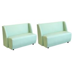 two light green leather sofas sitting next to each other