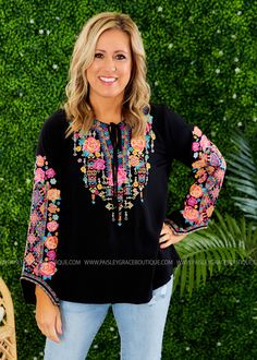 YOU'RE GOING TO LOVE COLORFUL EMBROIDERY ON THIS TOP! Black Bodice w/ Pink, Aqua, Yellow, and Multicolored Embroidered Print V-Neckline w/ Tassel Detail; Long Sleeves; Straight Hemline Lightweight Rayon Feel; We Feel Fits True to Size Bust Measured Laid Flat Across Front; Armpit to Armpit Small 19"; Medium 20"; Large 21"; 1XL 25"; 2XL 26"; 3XL 27" Length Measured Shoulder to Hemline Small 27"; Medium 27"; Large 28"; 1XL 30"; 2XL 31"; 3XL 32" 100% Rayon Models: Holly is wearing a Small; Lacey is Black Blouses For Women, Eid Outfit, Colorful Embroidery, Stylish Clothes For Women, Plus Size Womens Clothing, Embroidered Top, Trendy Dresses, Last One, Online Boutiques