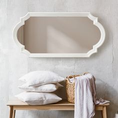 a mirror and some pillows on a table