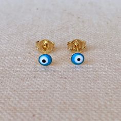 A dainty minimalist 18k Gold Filled evil eye stud earrings featuring aqua colored enamel finish. Metal: 18k Gold Filled Dimension: 2.5mm stud Weight 0.4 grams/ pair Hypoallergenic and waterproof jewelry Handcrafted in Brazil Learn how to care for your jewelry with these easy instructions. Properly handling and caring for your ArtBossa jewelry is essential in maintaining its pristine condition. 1. Keep your gold-filled jewelry away from chemicals and cleaning products. Remove your jewelry when handling them to keep it in good condition. 2. To protect your jewelry, don't apply perfume directly on it. Apply fragrance to your body first and wait a few minutes before putting on jewelry. Alcohol in perfume can damage your precious pieces. 3. Only clean the item with mild soap and water to mainta Yellow Gold Evil Eye Earrings For Gift, Prayer Ring, Turkish Eye, Waterproof Jewelry, Play Dress, Aqua Color, Birthstone Charms, Earring Sale, Gold Filled Jewelry