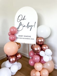 a baby shower sign surrounded by balloons