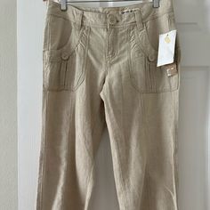 This Pair Of Women's Capri Cargo Pants From Dkny Jeans Is Brand New With Tags And Ready To Be Added To Your Wardrobe. The Pants Feature A Solid Pattern With Cuffed Hems And A Regular Fit. They Are Made From A Combination Of Linen And Cotton Materials, Providing A Comfortable And Breathable Wear. The Pants Come In A Beige Color And Have A Zip/Button Closure. Perfect For Both Casual And Workwear Occasions, These Pants Will Make A Great Addition To Any Outfit. Casual Fitted Capris With Pockets, Fitted Straight Leg Capris With Pockets, Mid-rise Wide Leg Pants With Hip Pockets For Spring, Spring Wide Leg Pants With Hip Pockets, Fitted Linen Mid-rise Bottoms, Fitted Mid-rise Linen Bottoms, Spring Mid-rise Linen Pants, Relaxed Fit Mid-rise Capris With Pockets, Linen Cargo Pants With Side Pockets, Ankle-length