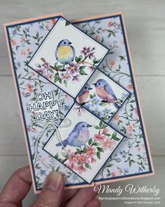 a hand holding up a card with two birds on it and the words oh happy day