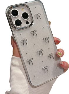 a woman is holding up her phone case with bows on the front and back sides