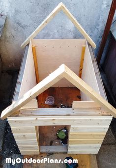 a house made out of plywood is shown in the process of being built and assembled