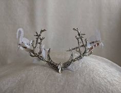 An ethereal woodland tiara featuring white leaves (including large white leaves) surrounding the piece and a moon charm with crystal in the center and two branches at its side. Perfect for weddings, cosplay, renaissance fairs, festivals, or any event of your choosing! White Crown Headpieces As Gift, Whimsical White Headband, Whimsical White Headband Headpiece, White Crown-shaped Party Jewelry, White Crown Jewelry For Party, Handmade White Headpieces As Gift, Handmade White Headpieces For Gifts, Handmade White Jewelry Headband, White Handmade Jewelry Headband