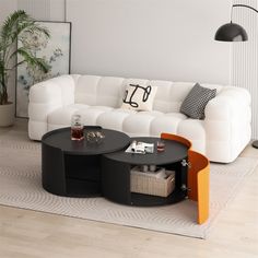 a living room with white couches and black tables in it's center area