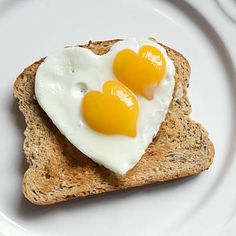 two eggs in the shape of hearts on toast