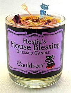 there is a candle that has a cat on the top and it says hestia's house blessing