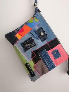 "Introducing our one-of-a-kind denim clutch, a unique and stylish accessory handcrafted from upcycled jeans. This rustic purse is the perfect gift for the fashion-conscious woman who values sustainability as much as she does style. Each piece is carefully crafted, featuring a chic patchwork design that brings together a range of denim shades, making every clutch a unique piece of wearable art. This denim clutch isn't just about style; it's about functionality too. The clutch measures approximately 8\"x5\", making it the perfect size to carry all your essential items like your phone, wallet, keys, and makeup. The sturdy denim material ensures durability, while the wristlet design adds convenience, allowing you to keep your belongings close at hand. The interior of the bag is lined with a so Everyday Denim Zipper Pouch Bag, Casual Clutch With Zipper Pouch, Casual Multicolor Everyday Pouch, Multicolor Casual Everyday Pouch, Casual Denim Zipper Pouch Bag, Casual Everyday Clutch With Zipper Pouch, Rectangular Denim Bag With Zipper Pouch, Casual Multicolor Zipper Pouch, Patchwork Pouch