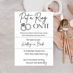 a table topped with silverware next to a card that says put a ring on it