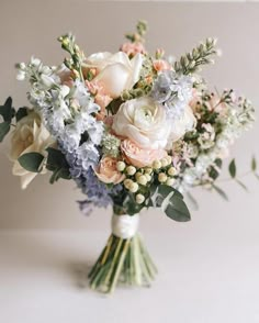 a bouquet of white and pink flowers on a table