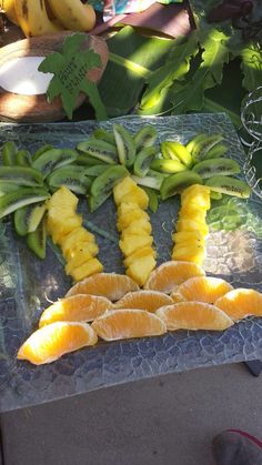 oranges and bananas cut up on a table