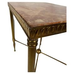 a table with a marble top and gold metal legs