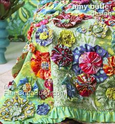 a woman wearing a colorful jacket with flowers on it