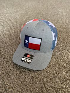 "This is a NEW Texas Flag embroidered patch applied by hand to a high quality Yupoong or Richardson brand SnapBack Trucker style hat Yupoong Classic SnapBacks are 65% Polyester/35% Cotton Structured mid-profile six-panel Permacurv Visor adjustable 6 7/8\" to 7 1/2\" Richardson Hats are 60% cotton/40% polyester Structured mid-profile six-panel Pre-curved Visor adjustable snapback closure 6 3/4\" -7 5/8\" Every Hat Design we offer is Created and Individually HANDCRAFTED to order in the USA! *Due t Hats With Patches, Curved Brim, One Size Fits Most, Trucker Baseball Cap With Embroidered Curved Brim, Embroidered Patch Snapback Hat With Curved Brim, Gray Hat With Logo Patch And Curved Brim, Trucker Hat With Embroidered Patch Curved Brim, Trucker Hat With Embroidered Logo And Curved Brim, Trucker Fitted Hat With Embroidered Logo, Adjustable Hat With Patches And Curved Bill, One Size Snapback Hats With Patches