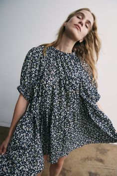 The Theo Dress is an oversized babydoll silhouette with elastic at the sleeve and neck. Floral print adds a pop of color and charm. Loose fit and flowy design in a lightweight seersucker fabric to add a subtle texture to the dress. 100% Japanese Cotton Seersucker Machine was delicate and hang to dry. Flowy Floral Print Dress With Puff Sleeves, Spring Dresses With Balloon Sleeves For Casual Occasions, Spring Balloon Sleeve Dress Down Dresses, Spring Dresses With Balloon Sleeves For Dress Down Occasions, Flowy Floral Print Midi Dress With Puff Sleeves, Summer Dresses With Smocked Bodice And Voluminous Fit, Flowy Dresses With Gathered Sleeves And Short Sleeve, Summer Voluminous Smocked Bodice Dress, Flowy Dresses With Gathered Short Sleeves