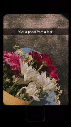 a bouquet of flowers sitting on top of a blue plate with the words got a photo from a fool