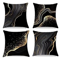 four black and gold decorative pillows on a white background, each with an abstract design