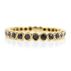 a yellow gold band with black diamonds