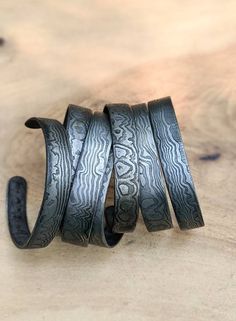 These bracelets are made to measures approximately 7 inches around and .5 inches in width. Although this is a unisex bracelet this size fits the average man's wrist (to give you an idea). If you would like a custom made size, please send us your wrist measurement with your order. Our damascus bracelets are hand forged from 1084 and 15n20. The damascus pattern varies with every bracelet; please expect that the one sent to you will be uniquely different in its own way. The photos show the general Damascus Bracelet, Stroudsburg Pa, Mens Cuff Bracelets, Rustic Bracelet, 11th Anniversary, Mens Cuff, Metal Bracelet, Industrial Metal, Mens Leather Bracelet