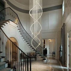 an elegant foyer with chandelier and marble floors