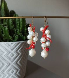 Handmade cluster earrings made with Freshwater Pearls, white color, and Red Coral branches. GOLD PLATED 925 STERLING SILVER Lenght : 5 cm / 1,97 inches * SHIPPING * Your order will be shipped within 1-3 business days from your purchase. You can choose between 2 shipping methods: STANDARD MAIL (NOT TRACEABLE) It is a cheap and fast shipping method, but NOT TRACEABLE. Chapeau Atelier is not responsible for any postal disruptions, delays or losses. REGISTERED MAIL (TRACEABLE) It is an absolutely sa Handmade White Dangle Cluster Earrings, Coral Jewelry Gift With Ear Wire, Coral Jewelry With Ear Wire For Gift, Gift Coral Jewelry With Matching Earrings, Coral Dangle Jewelry For Gifts, Unique White Dangle Pearl Earrings, Handmade Dangle Pearl Earrings For Gift, Handmade Coral Earrings For Party, Coral Dangle Earrings