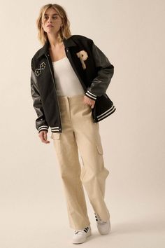 Felt and faux leather varsity bomber jacket. Flowers and letter "P" chenille applique patches. Contrasting faux leather sleeves. Side pockets with faux leather trim. Collared neckline. Zip-up front closure with snaps at top and bottom. Long sleeves. Dropped shoulders. Striped ribbed knit cuffs and hem. Yoke back. Quilted lining. Loose fit. 80% Polyester, 20% Cotton. Imported. Designed in LA. Model wears size S. Fall Varsity Jacket With Pockets, Varsity Jacket With Pockets For Fall, Varsity Jacket With Patches And Baseball Collar For Fall, Fall Varsity Jacket With Letter Patch, Fall College Style Varsity Jacket With Letter Patch, Trendy Varsity Jacket With Patches For College, Fall Season Varsity Jacket With Letter Patch, Trendy College Varsity Jacket With Patches, College Style Varsity Jacket With Letter Embroidery For Fall