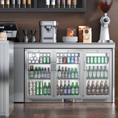 the refrigerator is full of beer and sodas next to an espresso machine