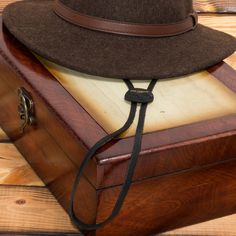 Western Chinstrap is an adjustable strap that can further secure the fit of your hat. It can be attached to any Panama, straw, or wool felt hat that contains a stitched-in sweatband. Simply slide the metal pins between the sweatband and inner hat, on both sides of the hat. It is made of 100% genuine cowhide leather. Easy installation. Caution: Follow the included instructions carefully to prevent any damage to the hat or sweatband. Should fit onto almost any straw Panama or felt hat. Securely ke Adjustable Short Brim Felt Hat For Outdoor, Adjustable Felt Hat With Short Brim For Outdoor, Adjustable Felt Hat For Outdoor, Adjustable Western Felt Hat For Outdoor, Adjustable Fit Felt Fedora For Outdoor, Classic Adjustable Brown Felt Hat, Country Style Hat Bands For Outdoor, Adjustable Curved Brim Felt Hat For Outdoor, Adjustable Flat Brim Felt Hat For Outdoor