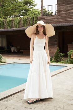 "The White Linen Halter Neck Midi Dress is a classic and timeless piece that belongs in every summer wardrobe. Made from high-quality linen fabric, this dress is lightweight, breathable, and perfect for hot and humid weather. The halter neck design of the dress adds a touch of sophistication and elegance to the overall look. The neckline sits high on the collarbone, providing coverage and support while still showcasing the shoulders and arms. The midi length of the dress falls just below the kne Classic Cotton Summer Dress, Classic Cotton Midi Dress For Summer, Classic Maxi Dress For Summer, Classic White Midi Dress For Summer, Classic White Midi Summer Dress, Classic Summer Dresses For Garden Party, Classic A-line Summer Maxi Dress, Classic A-line Maxi Dress For Summer, Classic Summer Day Dress